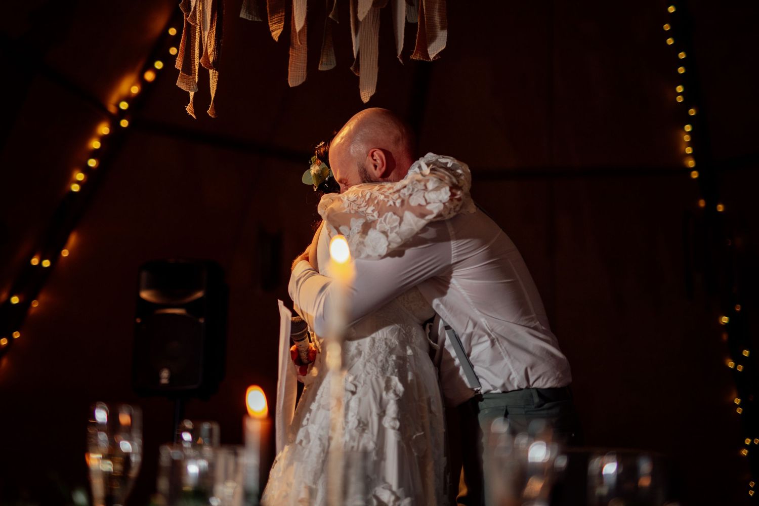 A romantic dance scene with string lights creating a warm ambiance in the background.