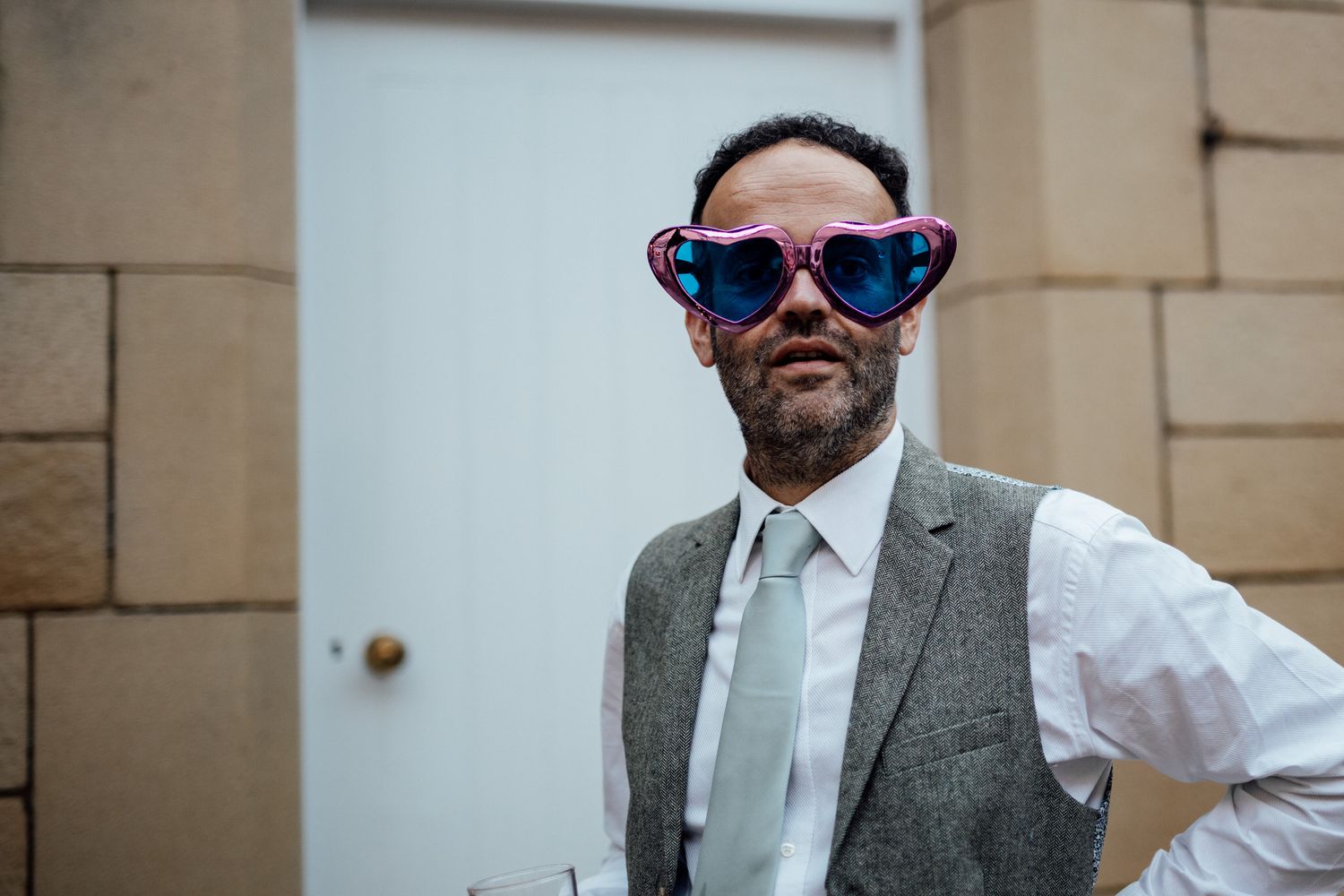 Casual outdoor wedding portraits with sunglasses and relaxed poses.