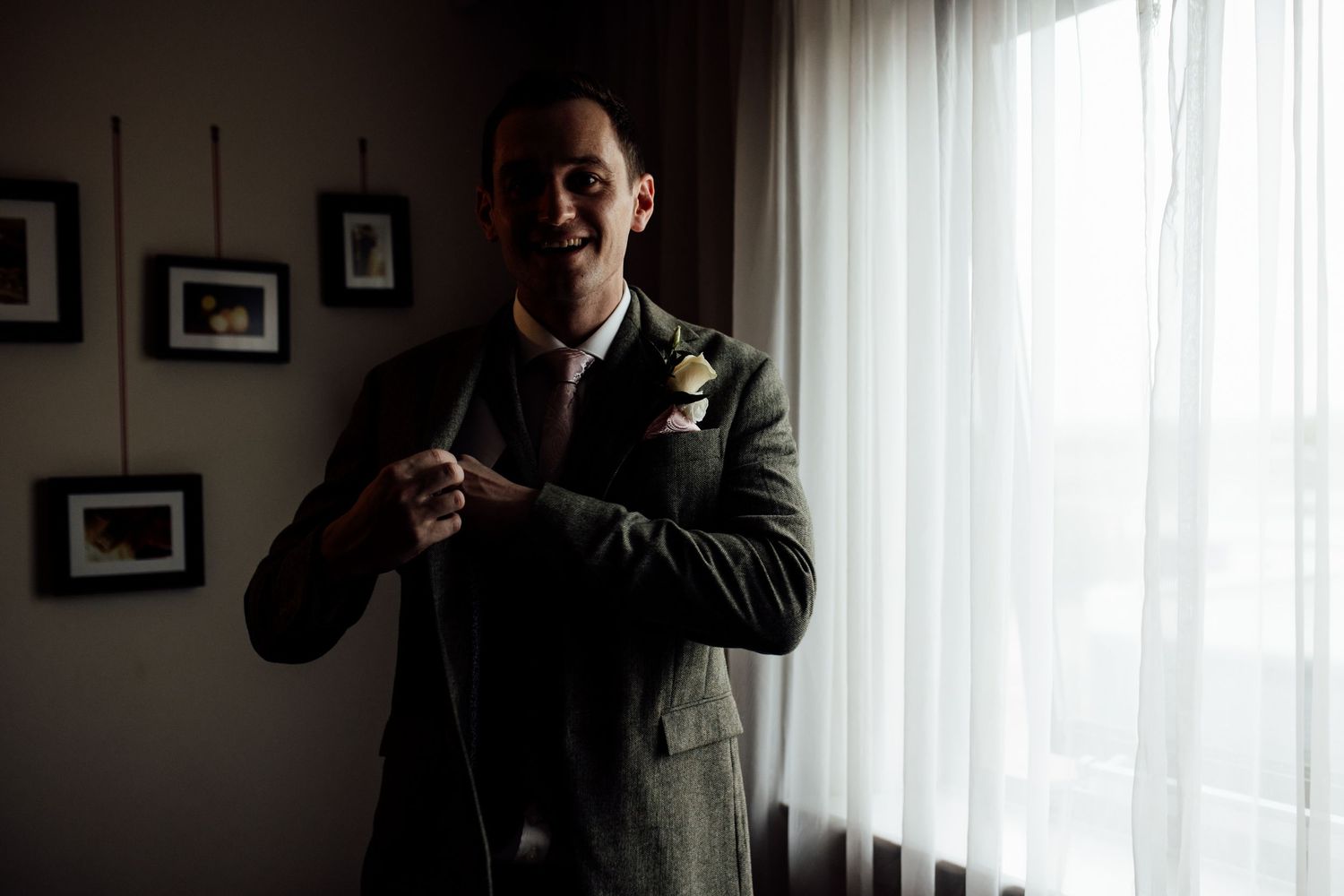 Elegant indoor wedding preparation scene with natural window lighting.