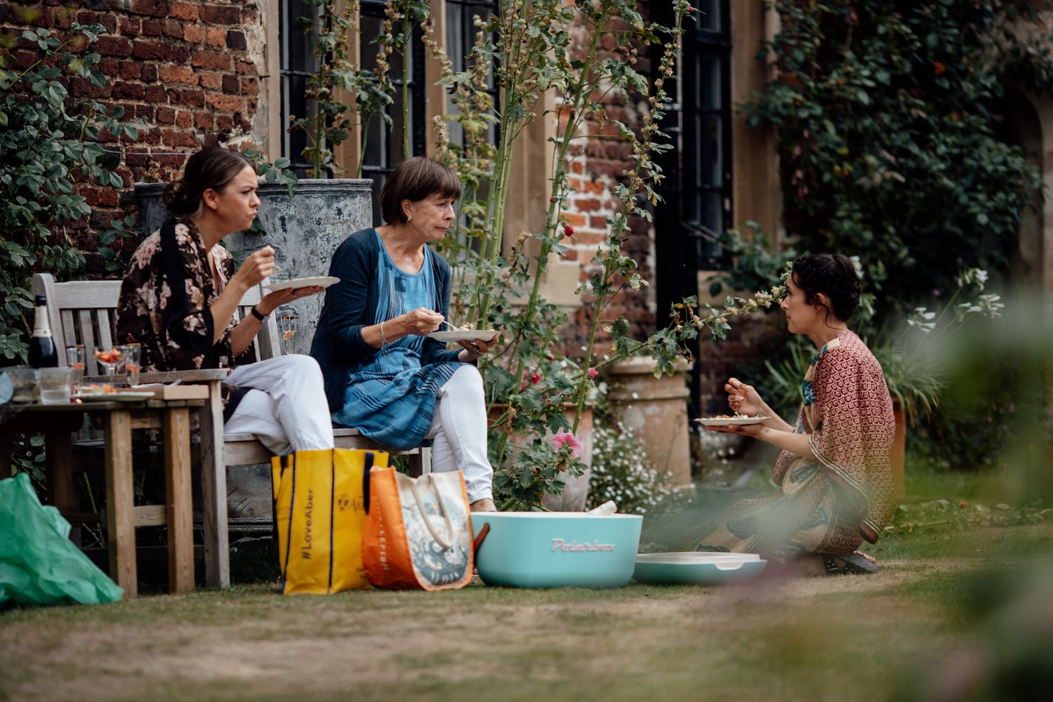 A charming outdoor garden setting with rustic brick walls and greenery.