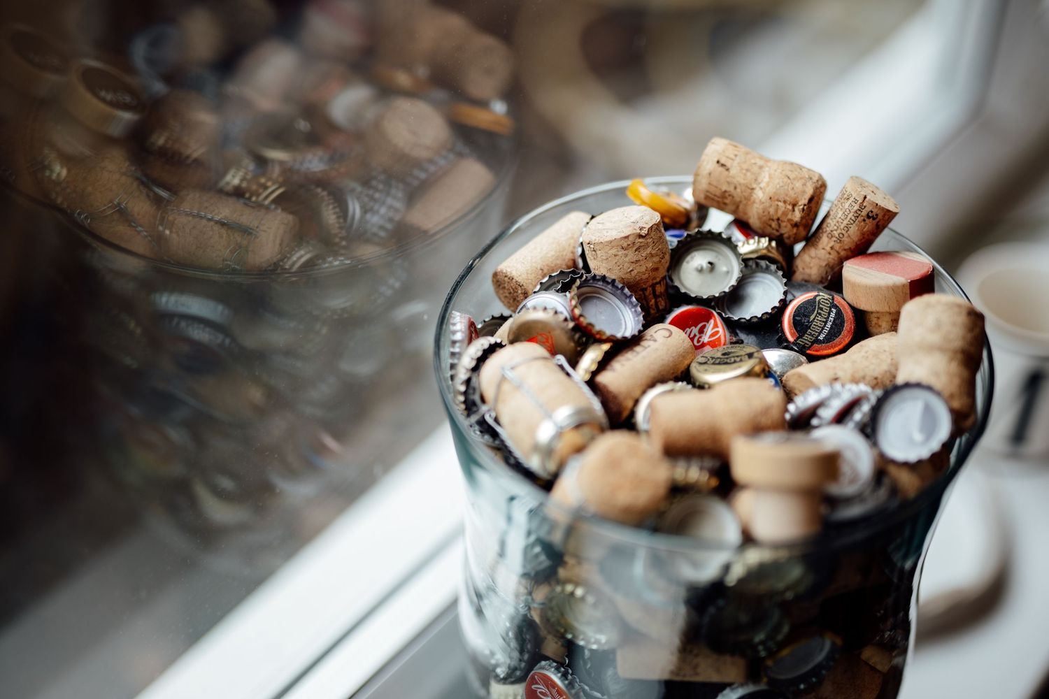 Close-up of wedding rings and jewelry details in glass container.
