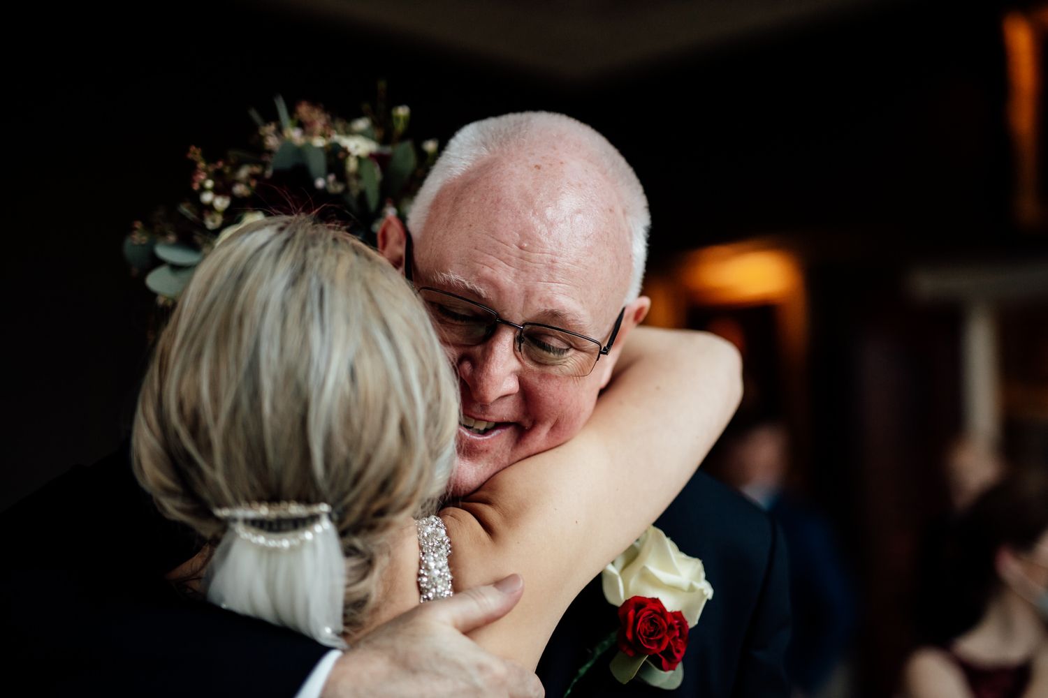 Emotional moment shared between wedding guests during reception celebration.