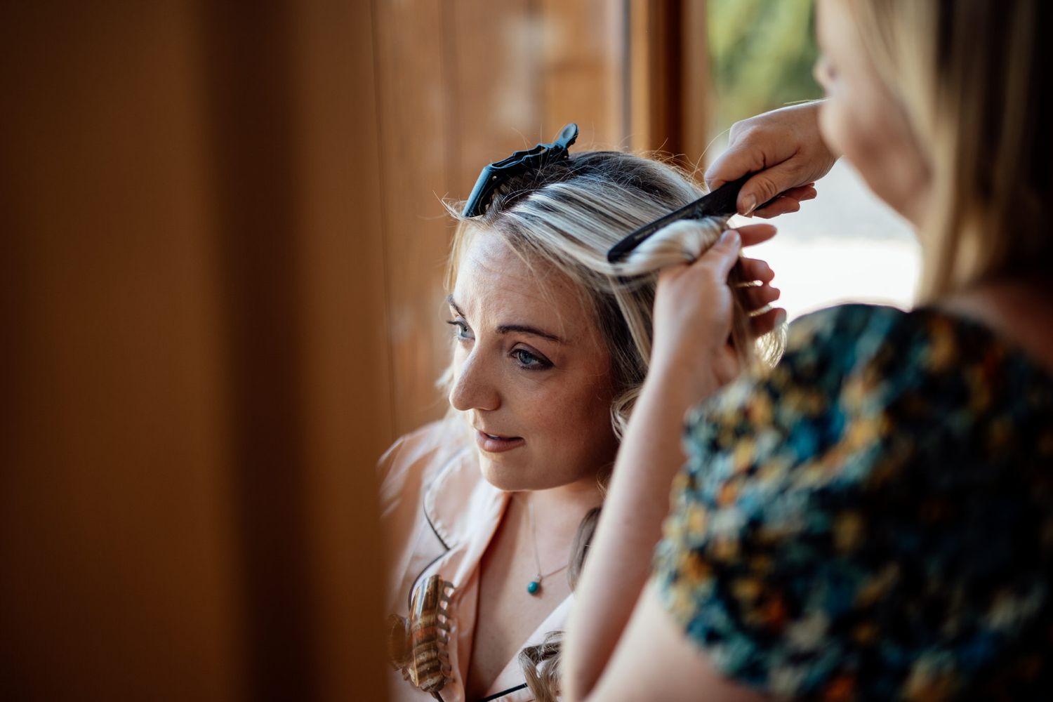 Close-up shots of wedding day makeup application in warm natural lighting.