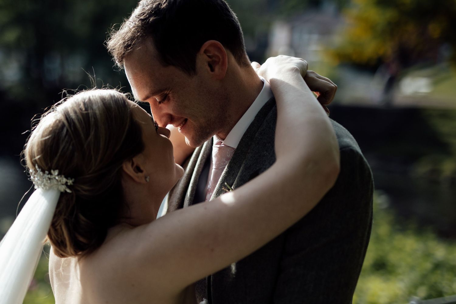 Intimate wedding couple portrait captured in natural outdoor lighting.