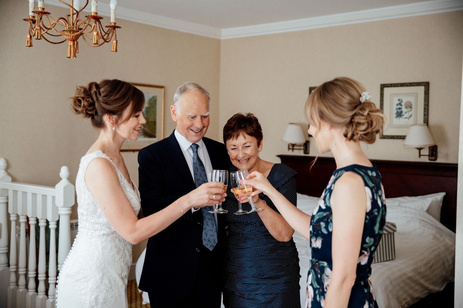 Wedding party members share emotional moments during preparation in an elegant room.