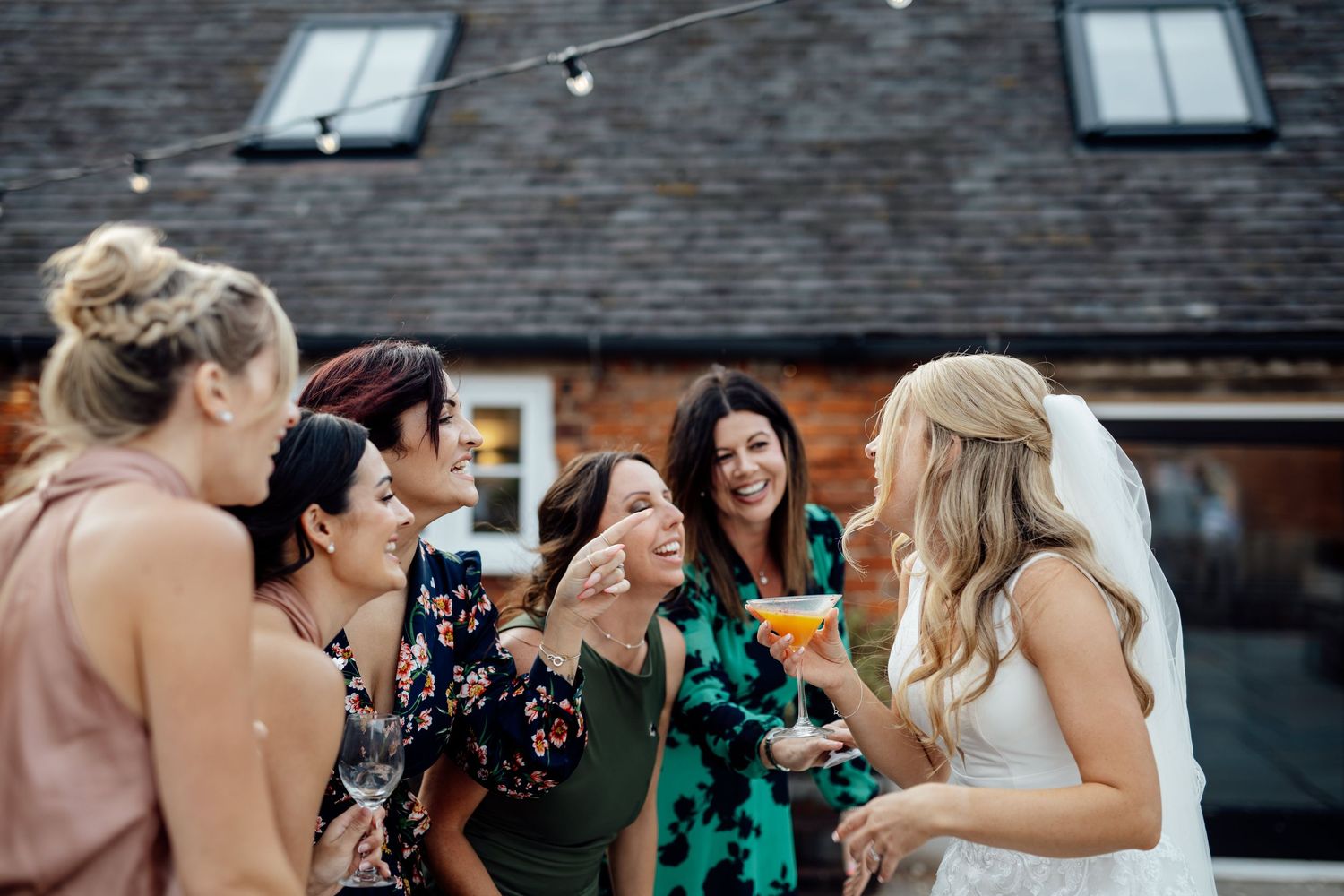 Wedding celebration with guests mingling at outdoor brick venue.