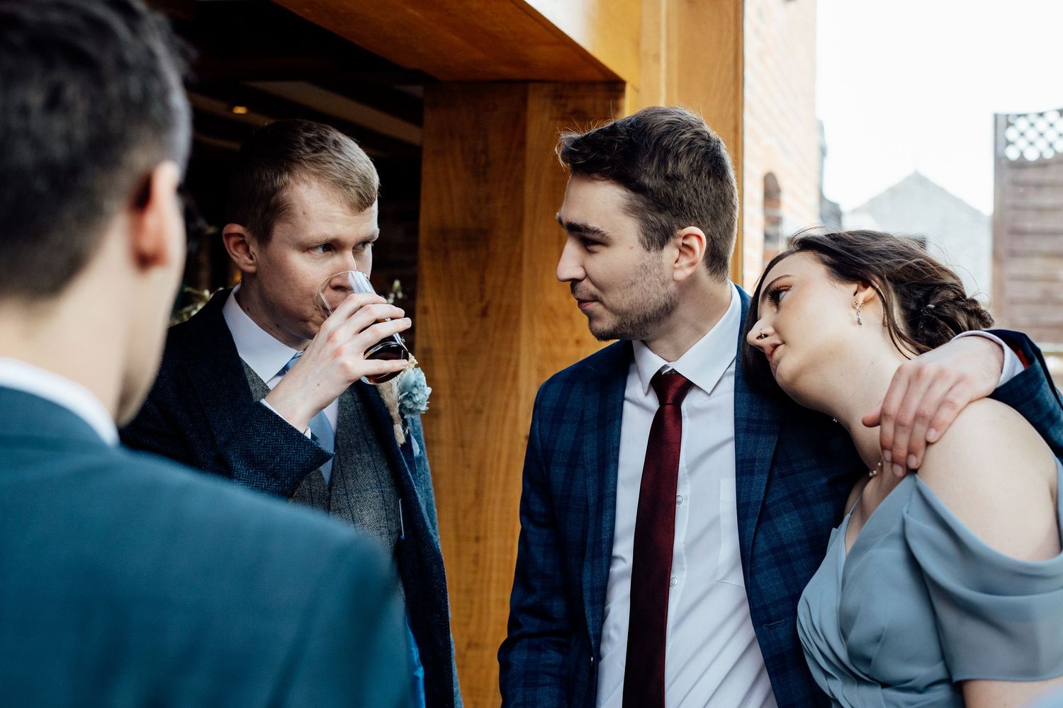 Wedding guests socialize and share drinks during the reception.