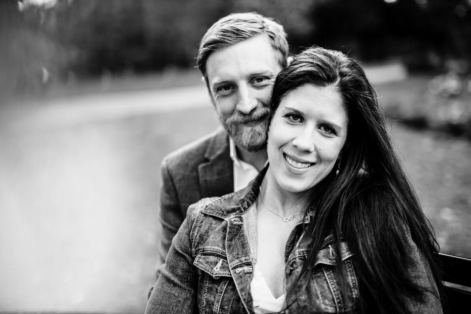 Black and white portrait of couple sharing romantic moment outdoors.