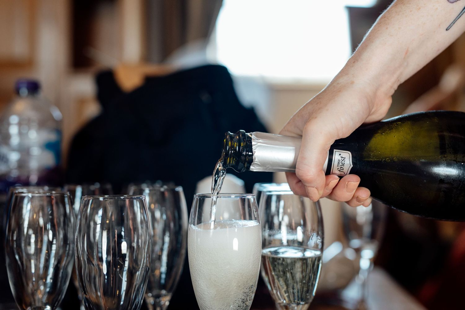 Champagne being poured into glasses at an elegant wedding reception.