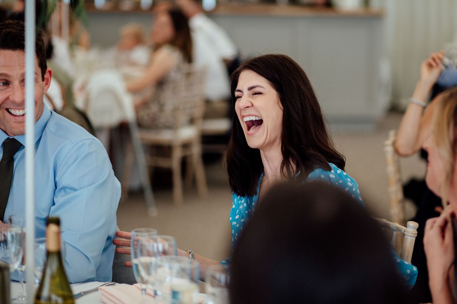 Wedding guests sharing laughs during the reception dinner.