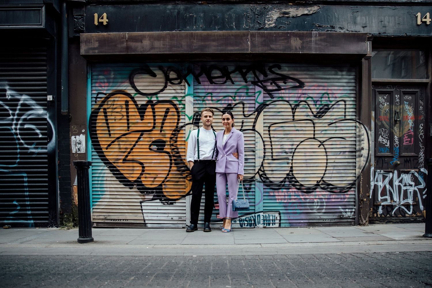 Street scene with graffiti covered walls and people walking in the distance.