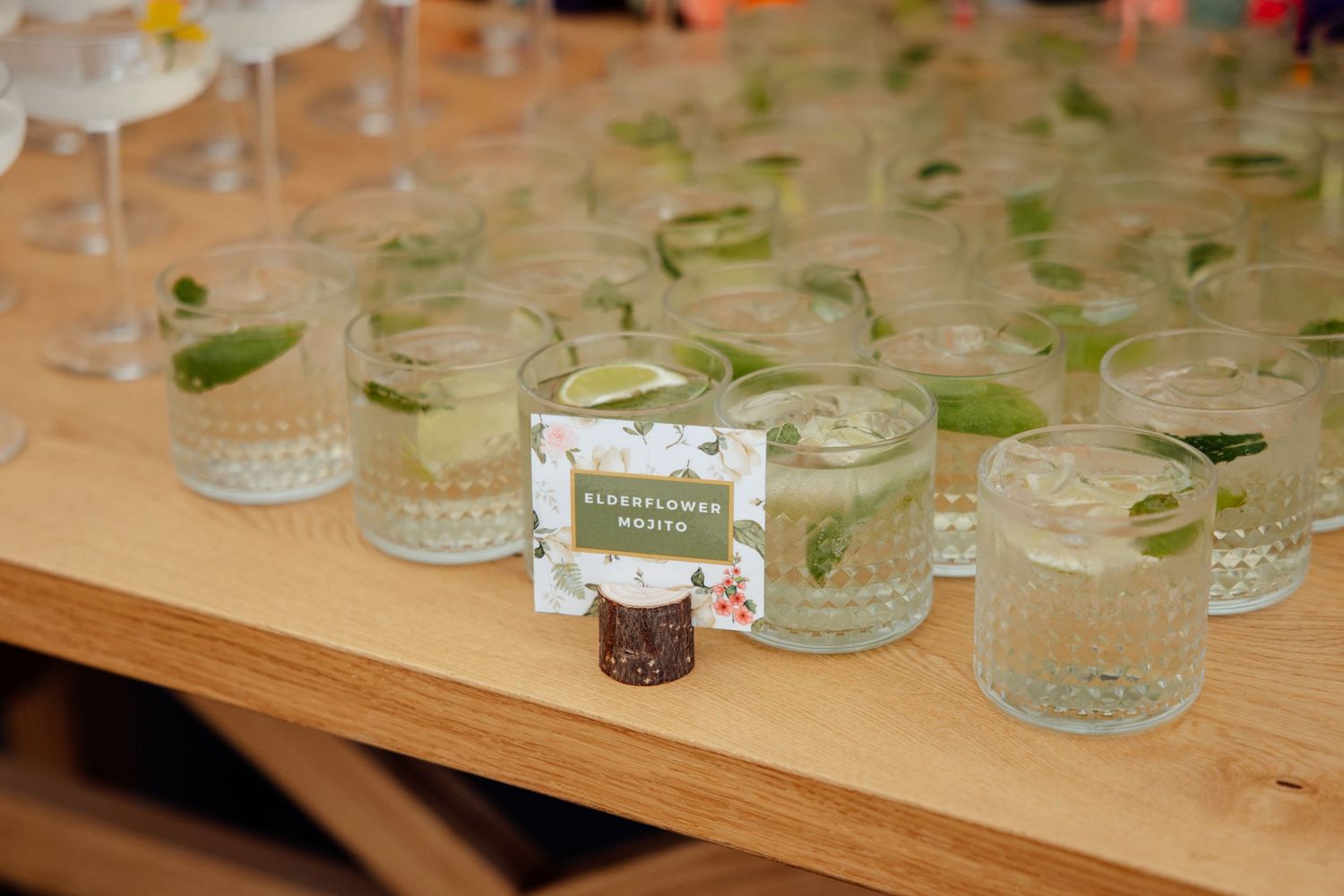 Wedding reception table details with glass jars and greenery decorations.