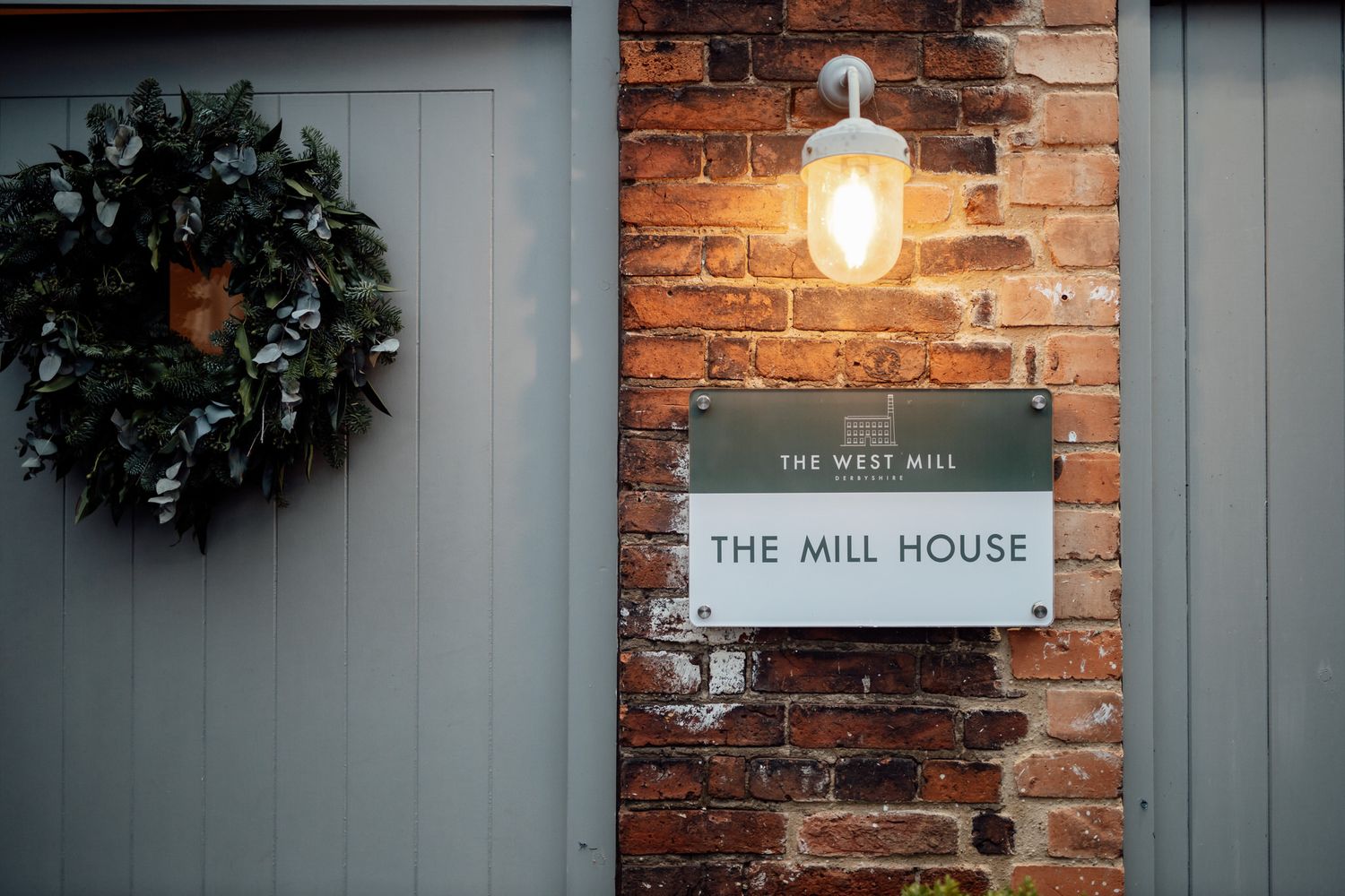 Exterior shot of The Mill House with brick walls and grey trim.