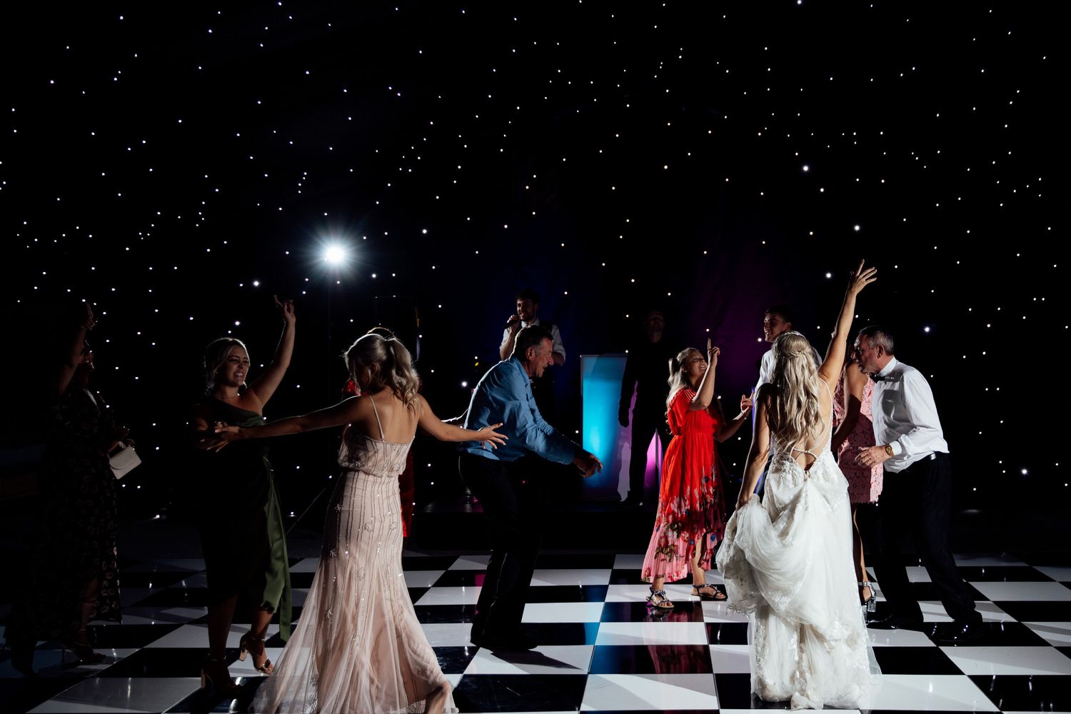 Dance floor celebration with starry light effects and party atmosphere.