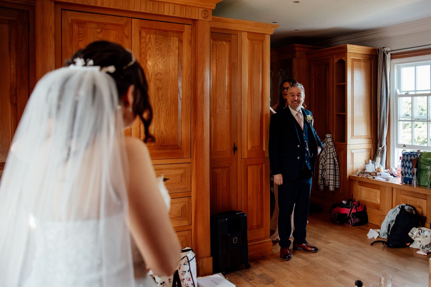 Wood-paneled room with large windows serves as an elegant wedding venue.