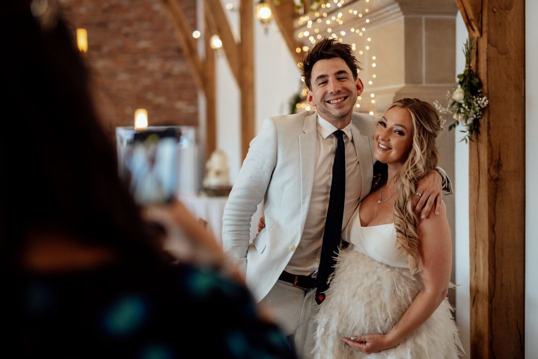 Wedding celebration in rustic venue decorated with twinkling lights and romantic ambiance.