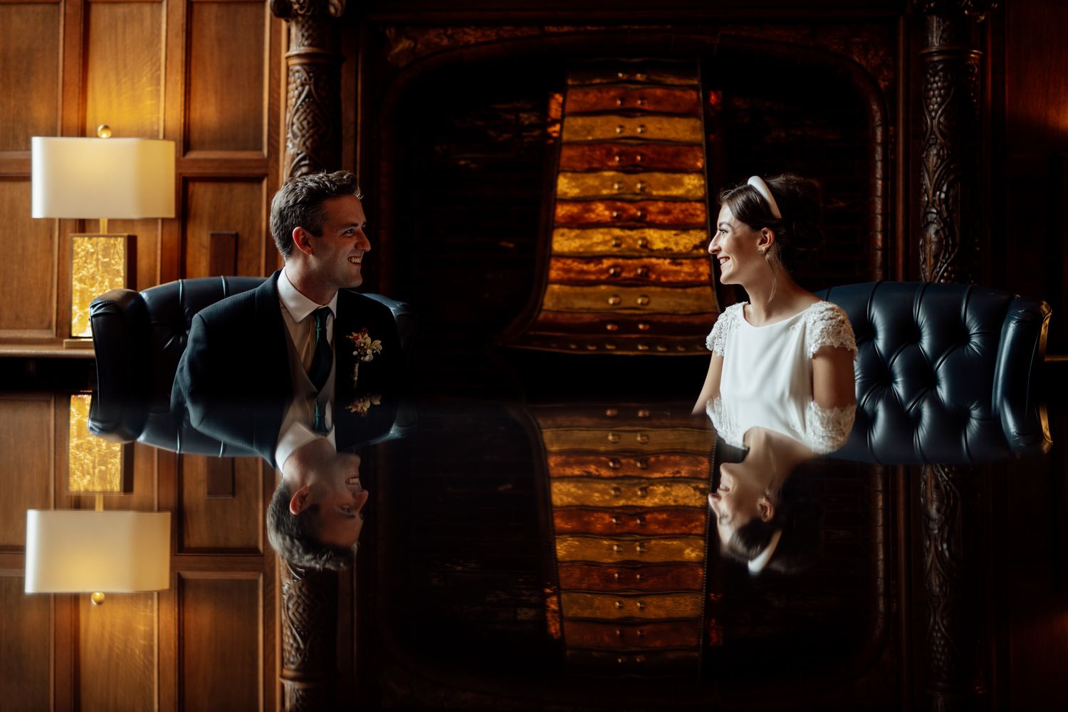 Elegant indoor wedding venue with warm lighting and wood paneled walls.