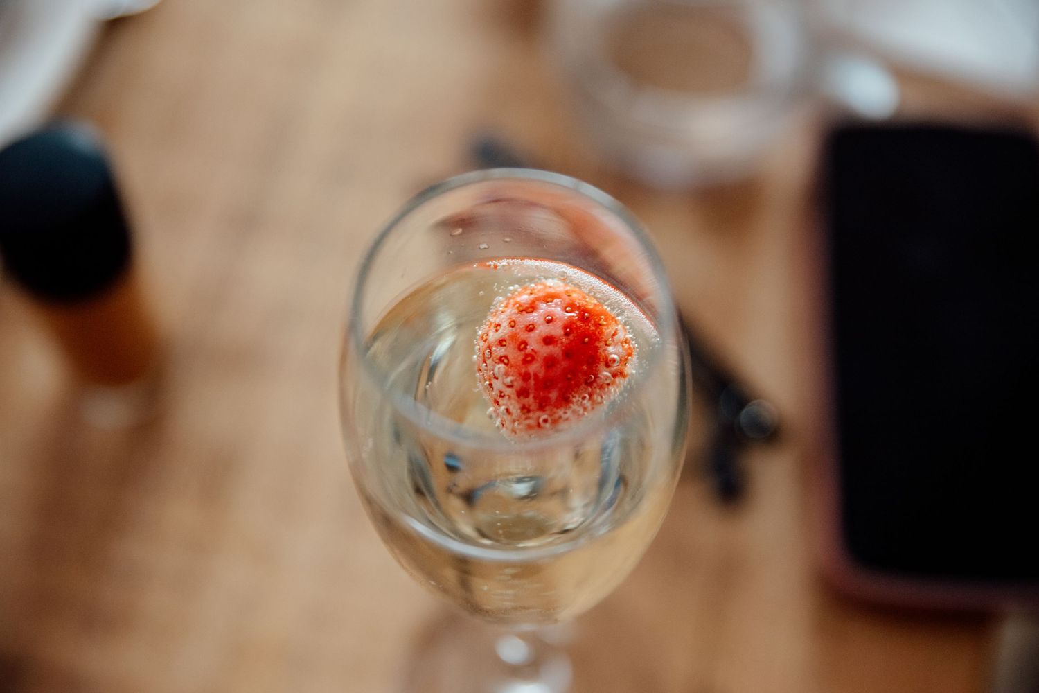 Close-up of cocktail glasses with strawberry garnish at wedding reception.