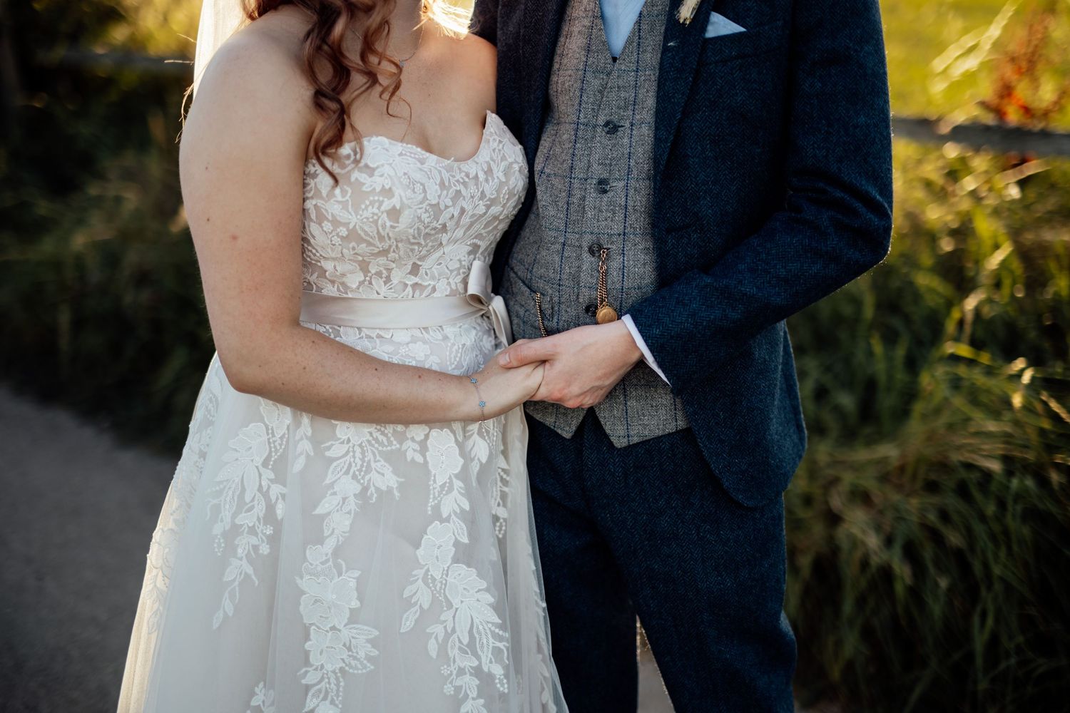 Elegant wedding couple posing together during golden hour portrait session.