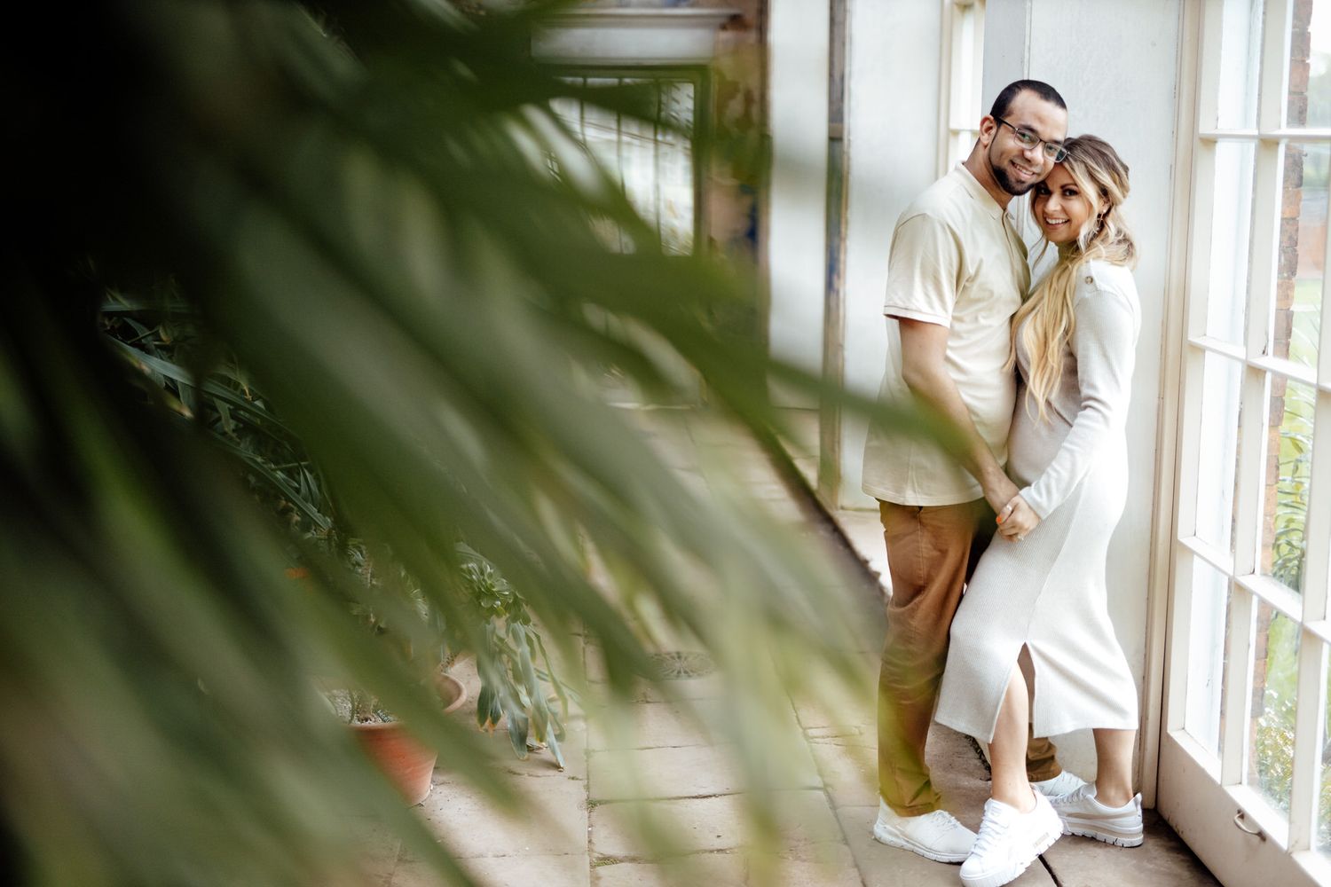 Indoor lifestyle photoshoot with natural window light and tropical plant shadows.