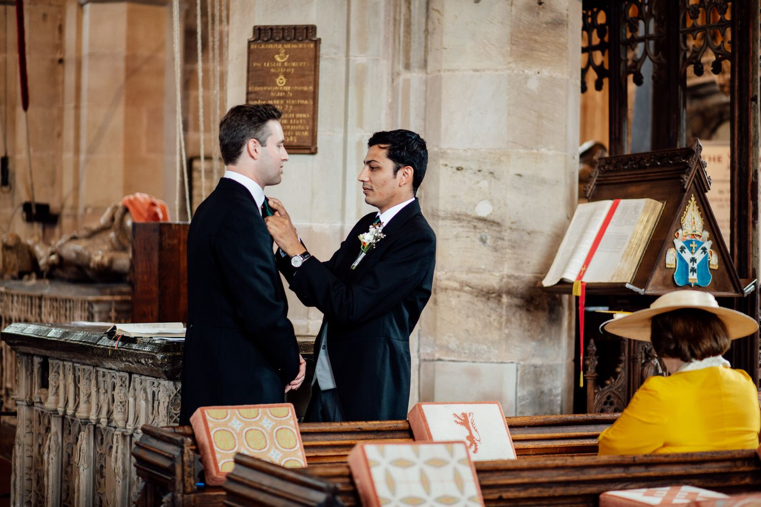 Candid wedding moments captured in a historic stone building setting.