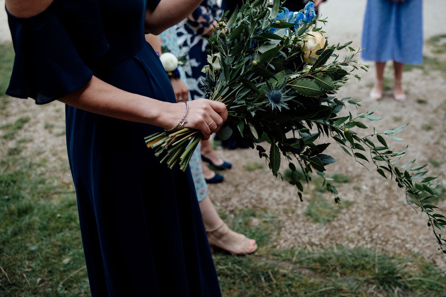 Elegant floral bouquets with white and blue flowers arranged for a wedding celebration.