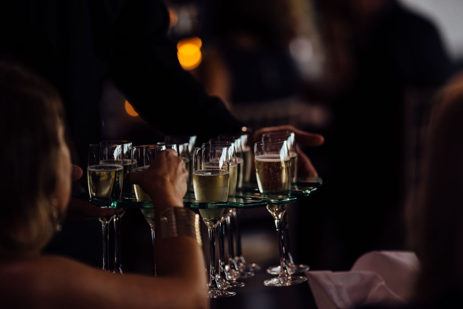 Dimly lit reception venue with glowing candlelight and table settings.