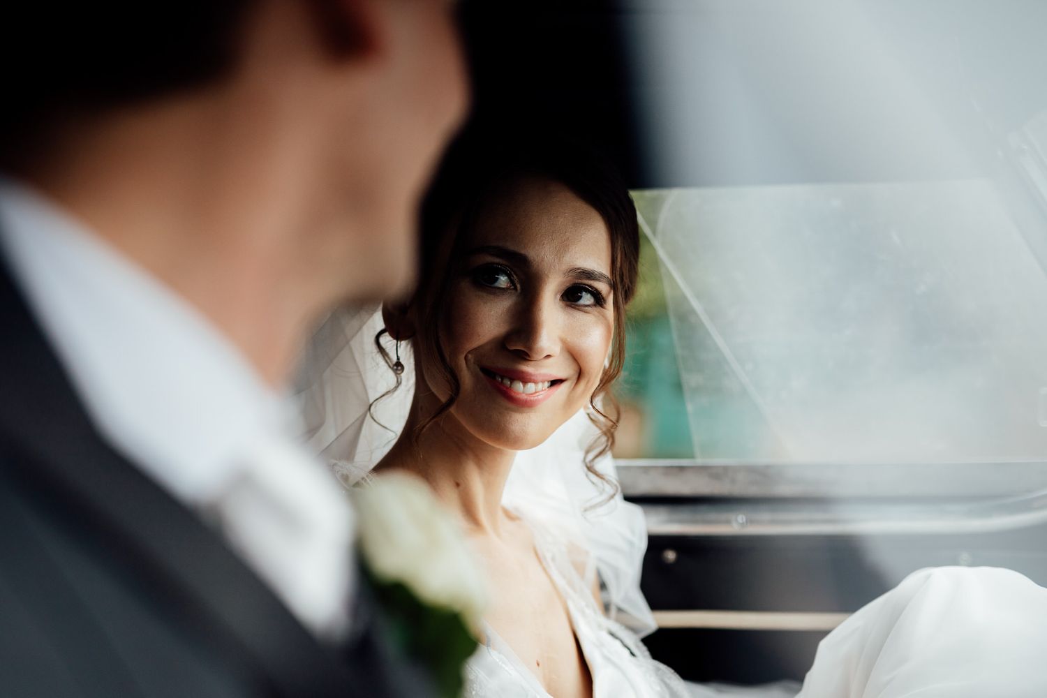 Elegant wedding scene captured through a car window.