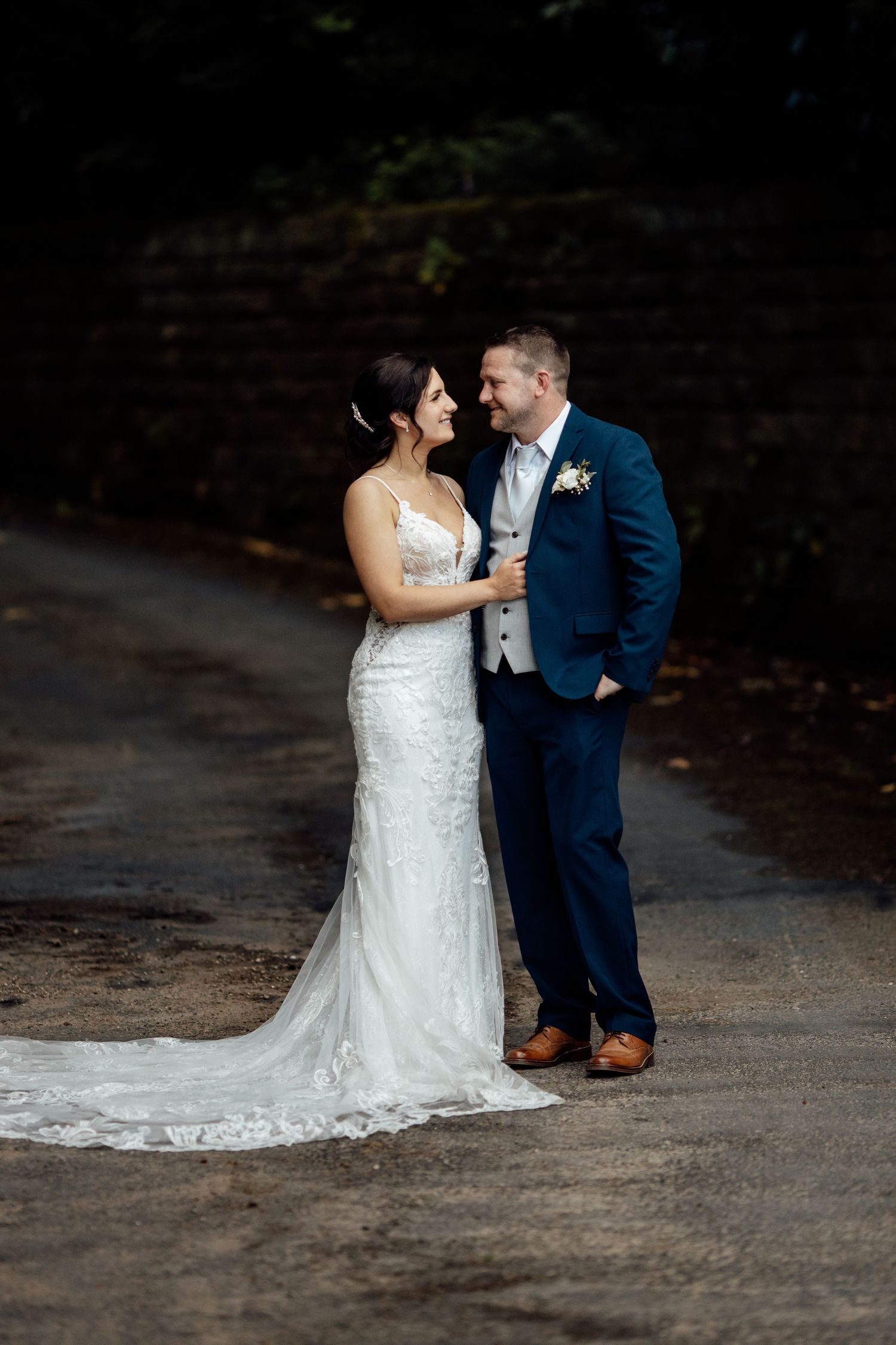 Wedding couple sharing intimate moments on a rustic path.