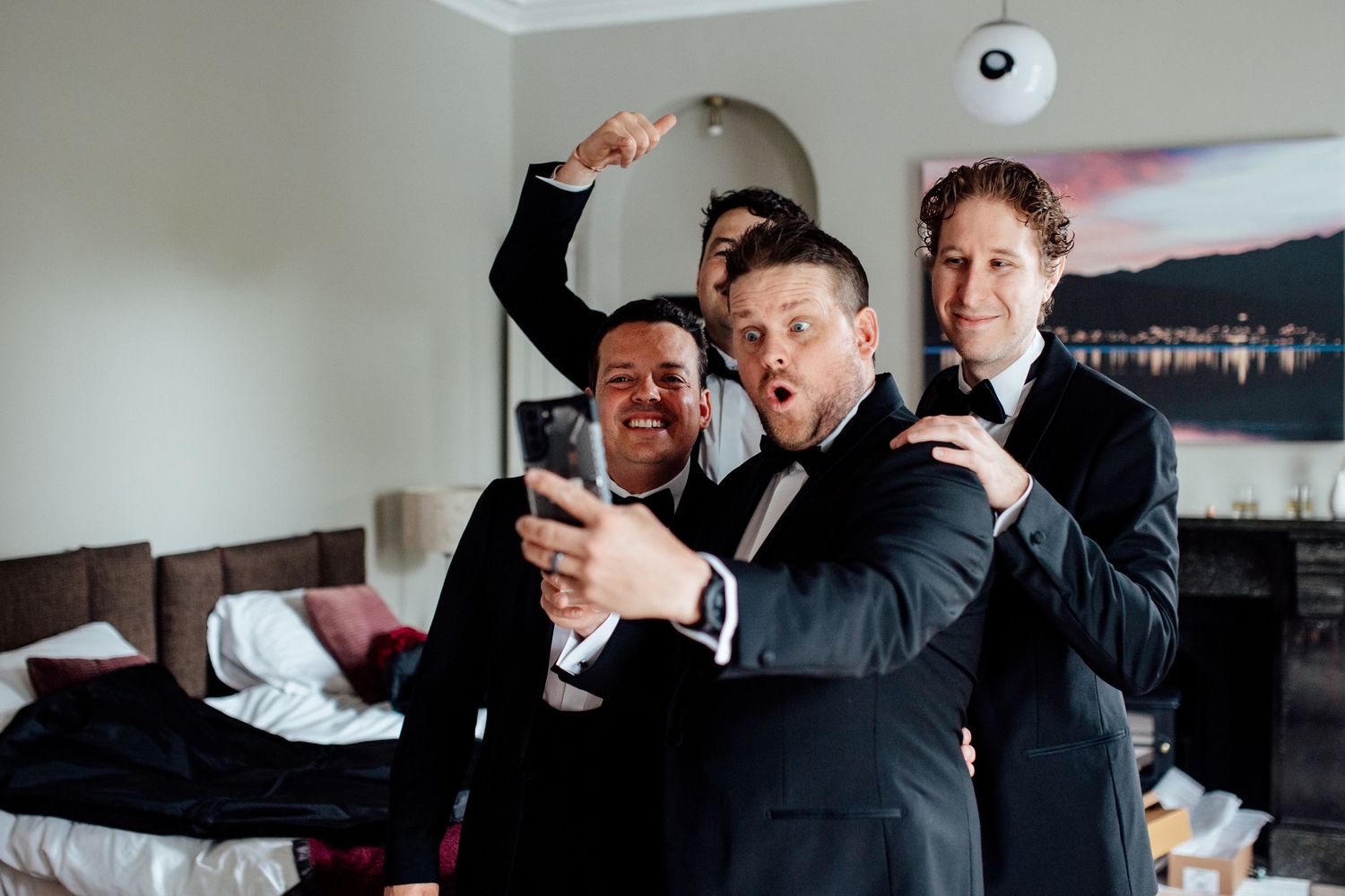 Group of people in formal attire preparing for a celebration indoors.