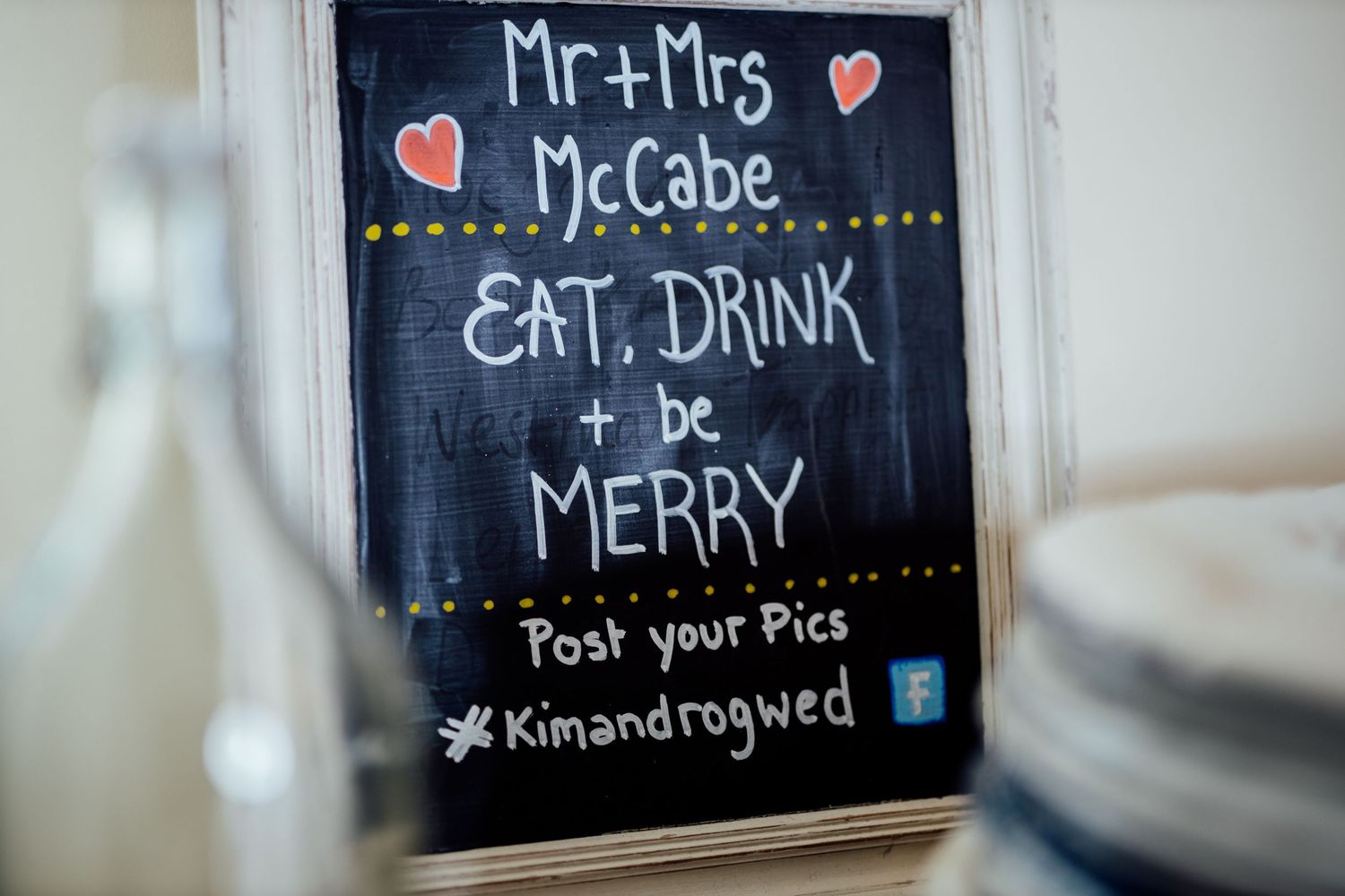 Chalkboard wedding signs display 'Mr & Mrs McCabe' and reception details.
