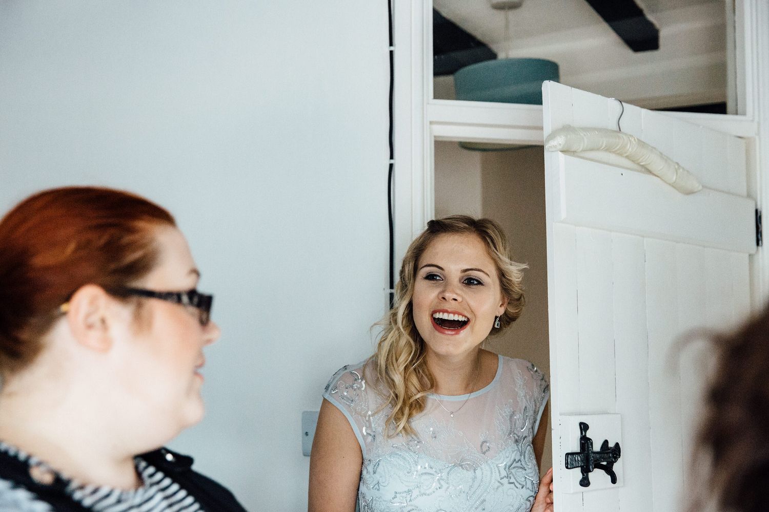 Wedding preparation moments captured in bright natural window light.