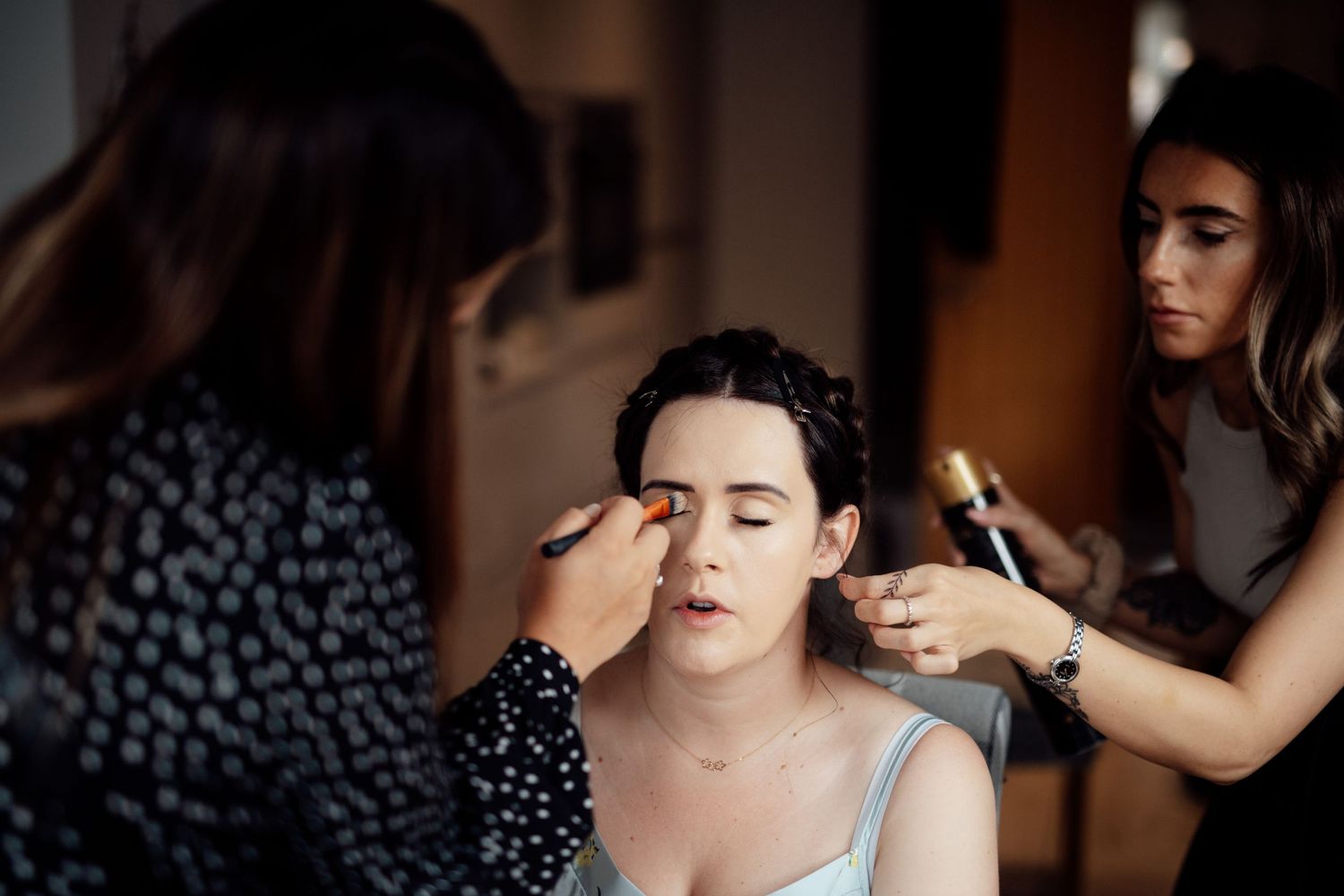 Wedding day preparation moments captured in intimate indoor setting.