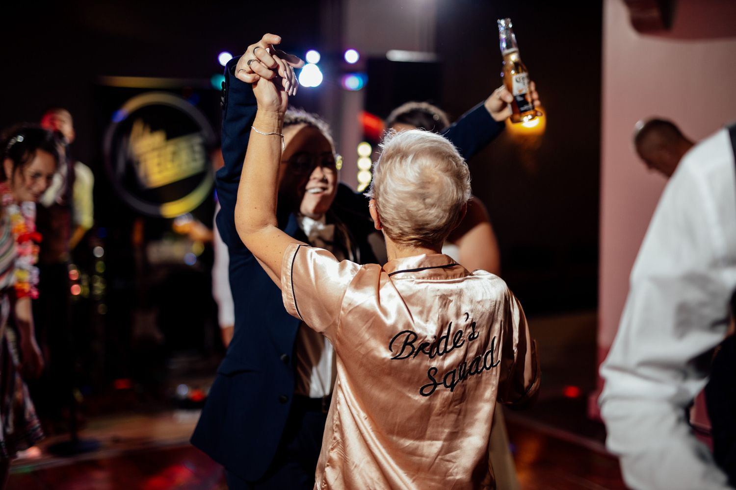Wedding reception party with guests raising glasses for a celebratory toast.