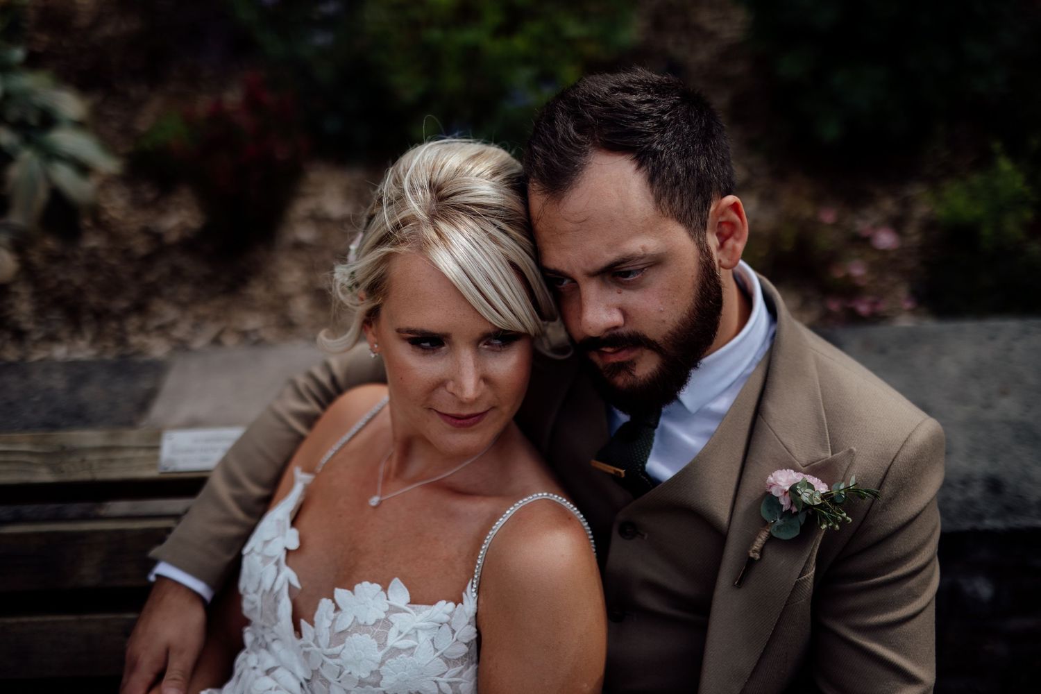 Couple sharing an intimate moment outdoors in natural lighting.