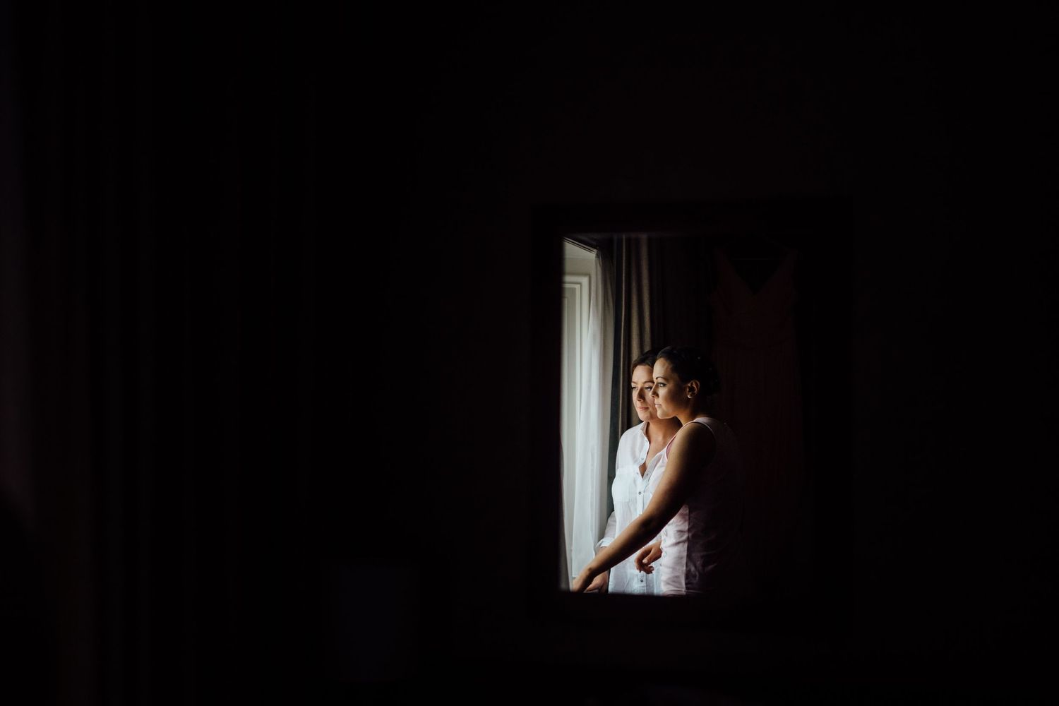 Dark moody interior shot with window light streaming in.