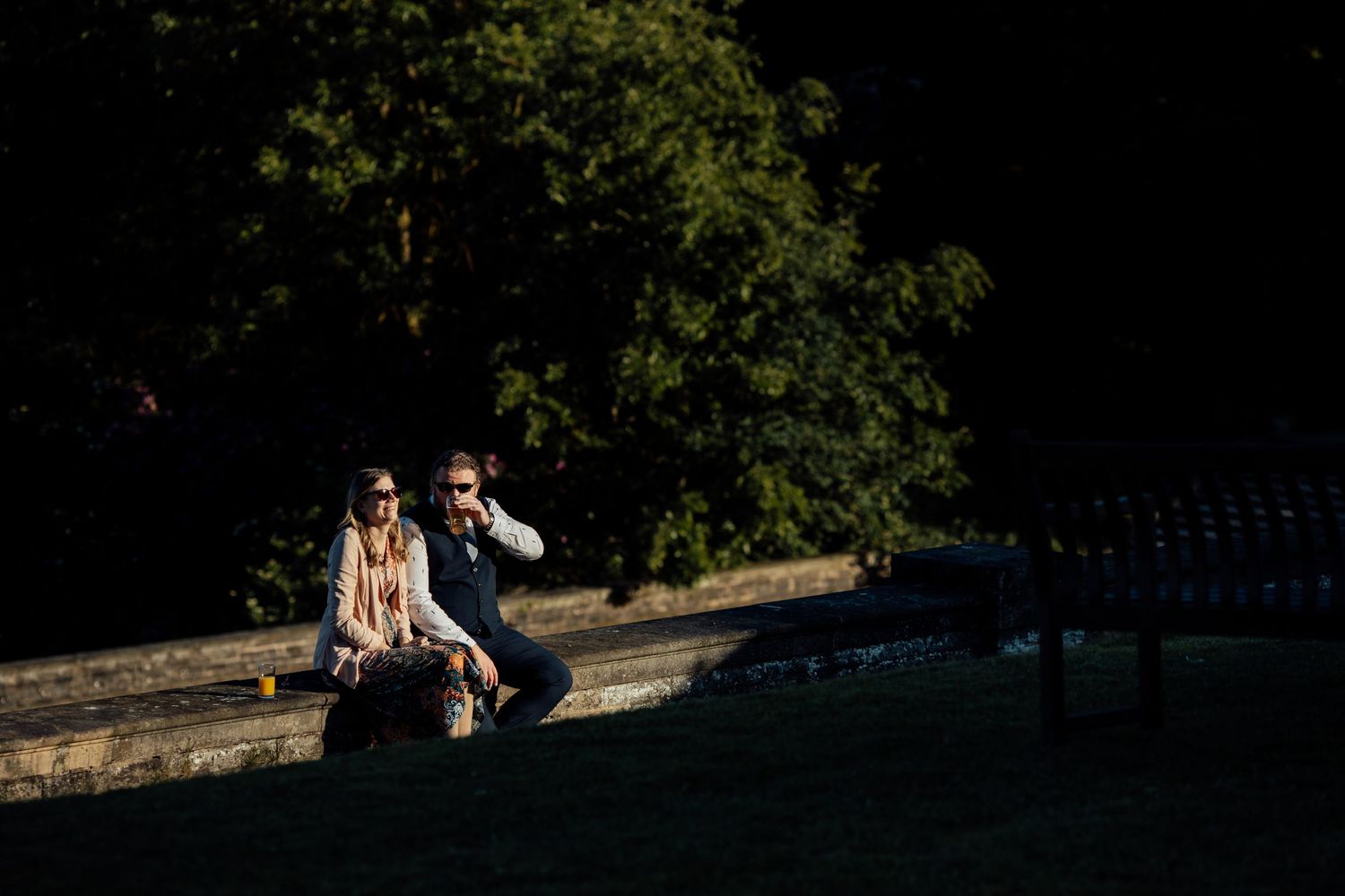 Wedding couple posing for photos in a scenic outdoor garden setting.