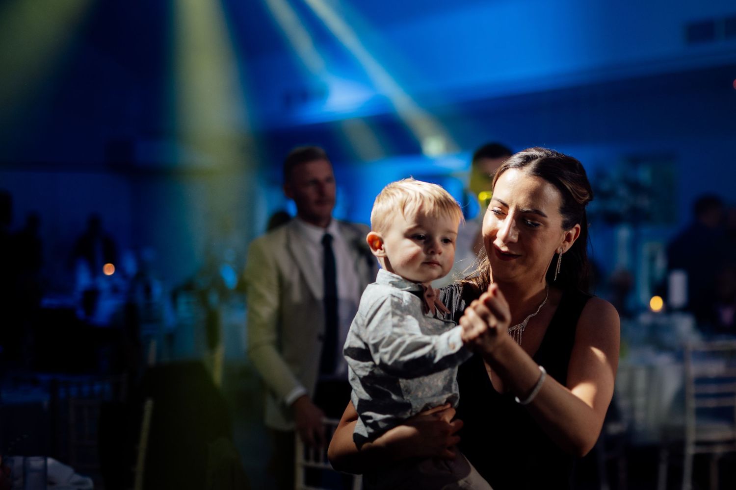 A tender moment on the dance floor with a small child during the wedding reception.