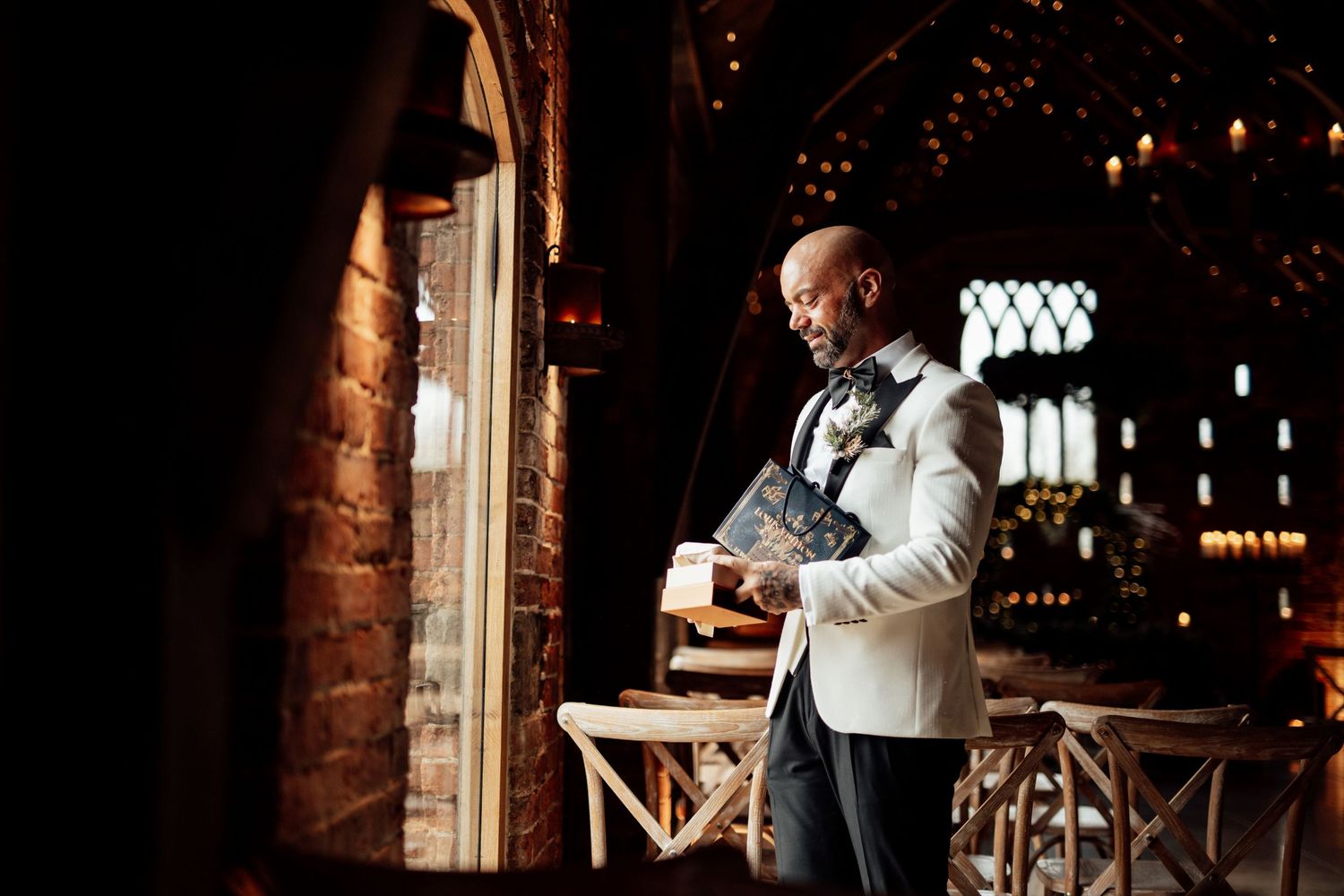 Rustic brick venue interior with warm lighting and elegant decor for an evening event.