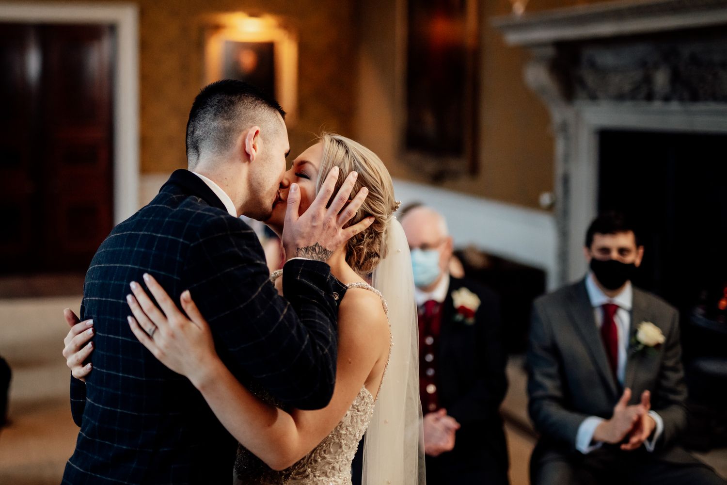 Intimate wedding dance moment captured in warm ambient lighting.