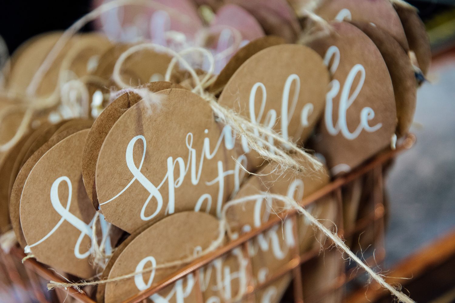 Rustic wooden name cards with elegant calligraphy displayed at a wedding.