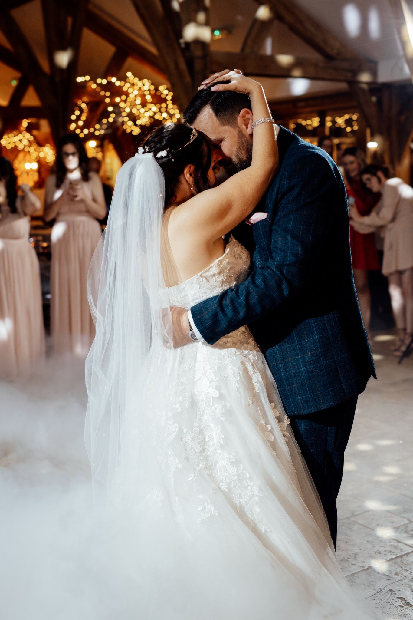 First dance at wedding reception with fog effect and romantic lighting.