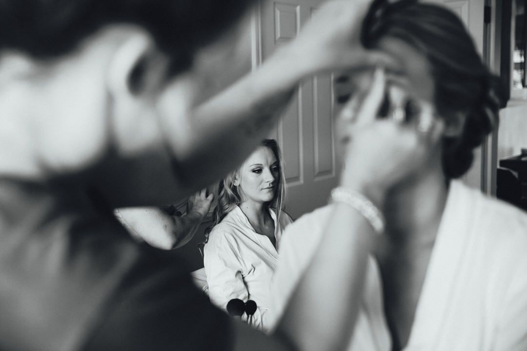 Black and white candid moments during wedding preparation.
