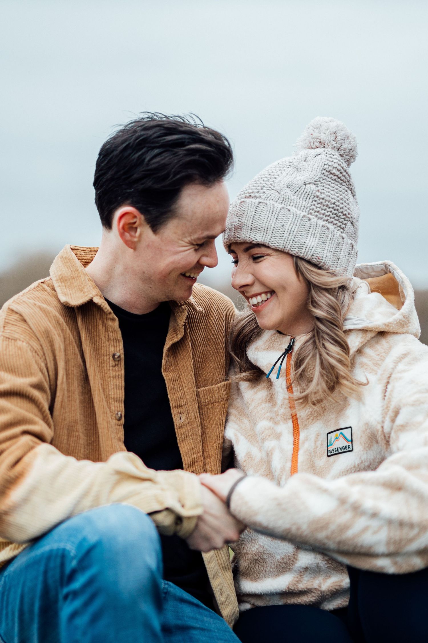 Candid winter moment captured with warm clothing and genuine laughter.