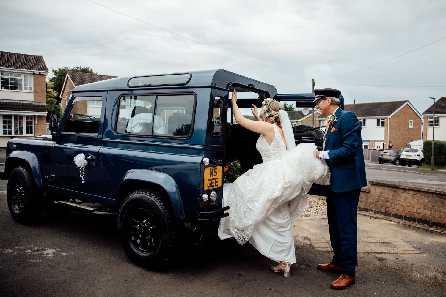 Classic Land Rover vehicles parked outside during a wedding photoshoot.