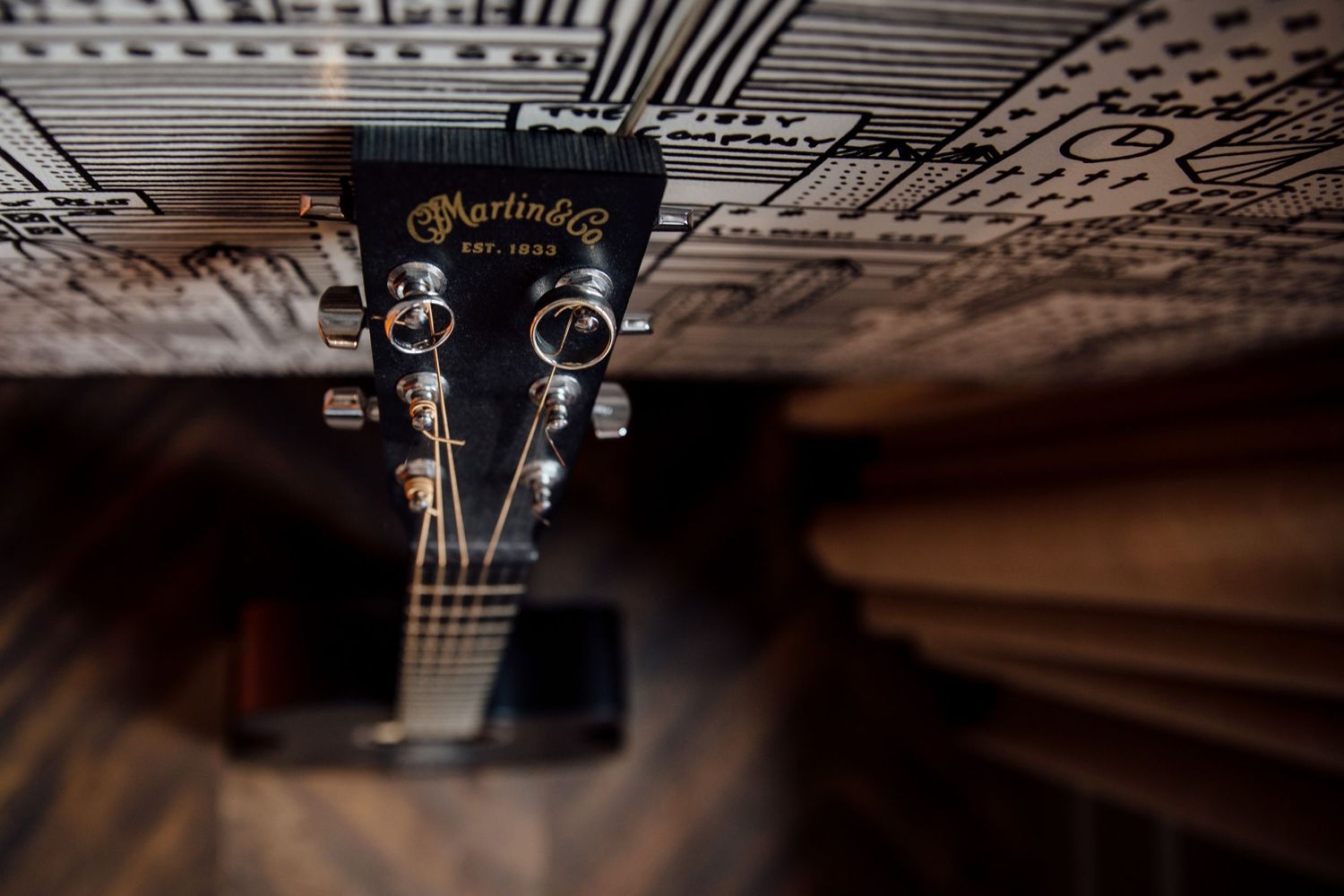 Abstract pattern of guitar headstock and tuning pegs in macro photography.