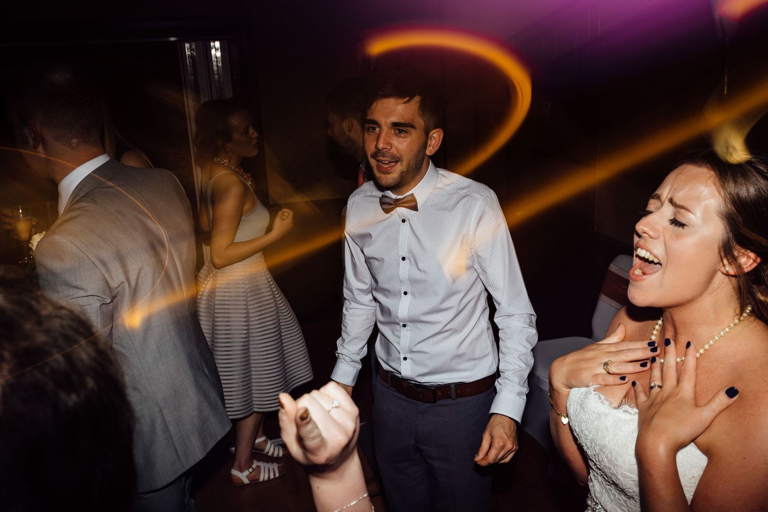 Wedding reception dance floor with colorful lighting and celebration atmosphere.