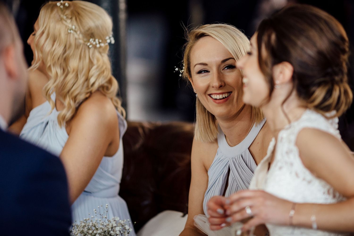 Candid reception moments with bridesmaids in light gray dresses.