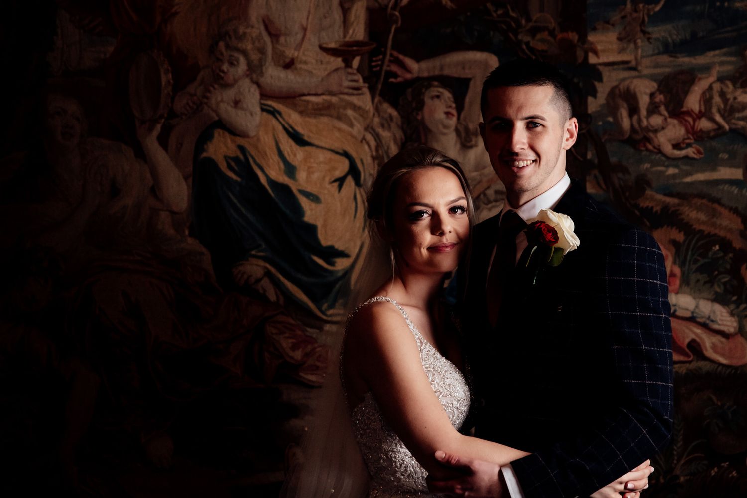 Romantic dance captured in low light against vintage wallpaper background.