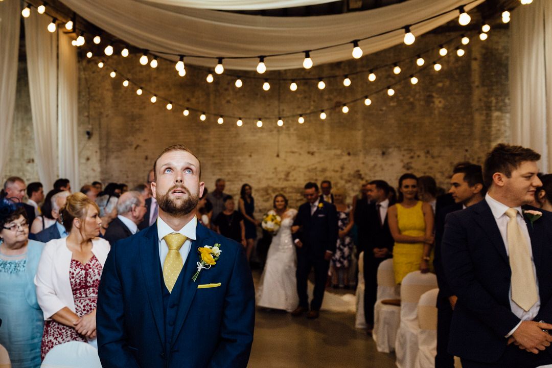 String lights create a magical atmosphere in a rustic wedding venue.